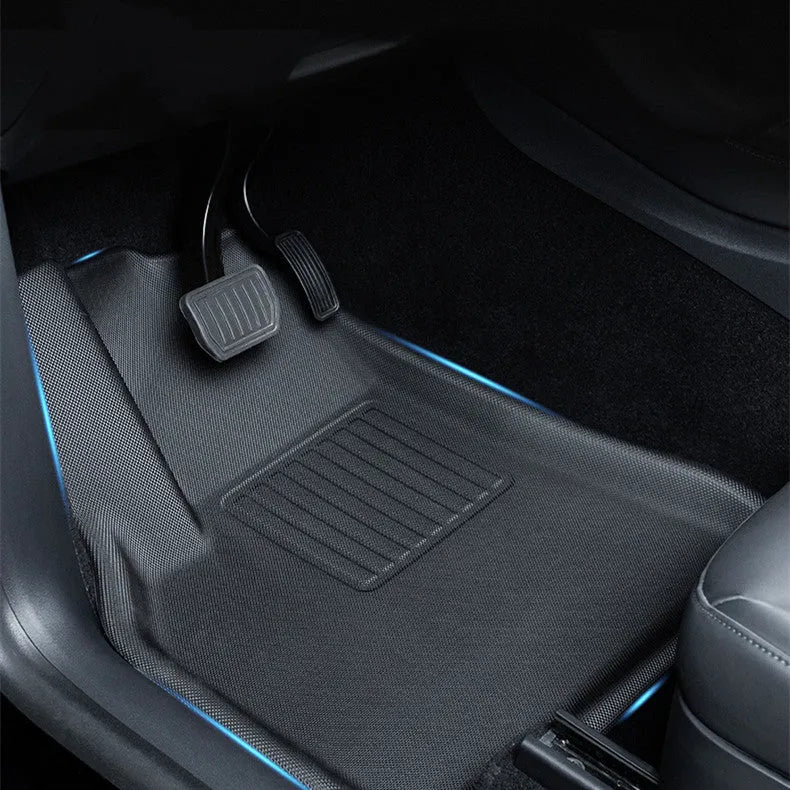 Set of four textured TPR floor mats for a Tesla Model Y, showing foot mats and storage box mats.