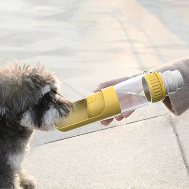 Dark blue portable dog water bottle with integrated drinking bowl showing measurement scale