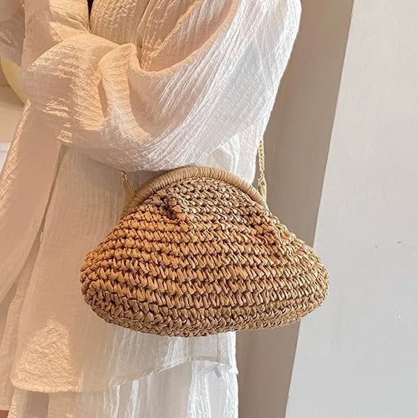 Women's straw handbag with shell shape, chain detail, and khaki colour option
