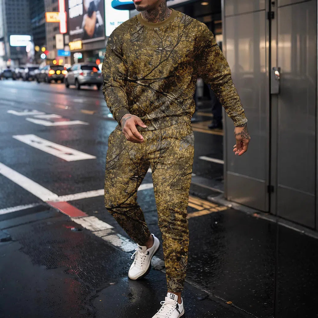 Two-piece jungle camouflage sportswear set with long-sleeve round neck top and matching trousers on a male model