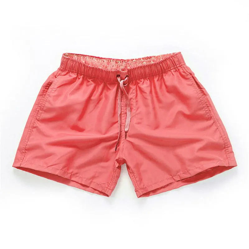 Men's polyester beach shorts in black, shown laid flat, featuring a straight leg opening.