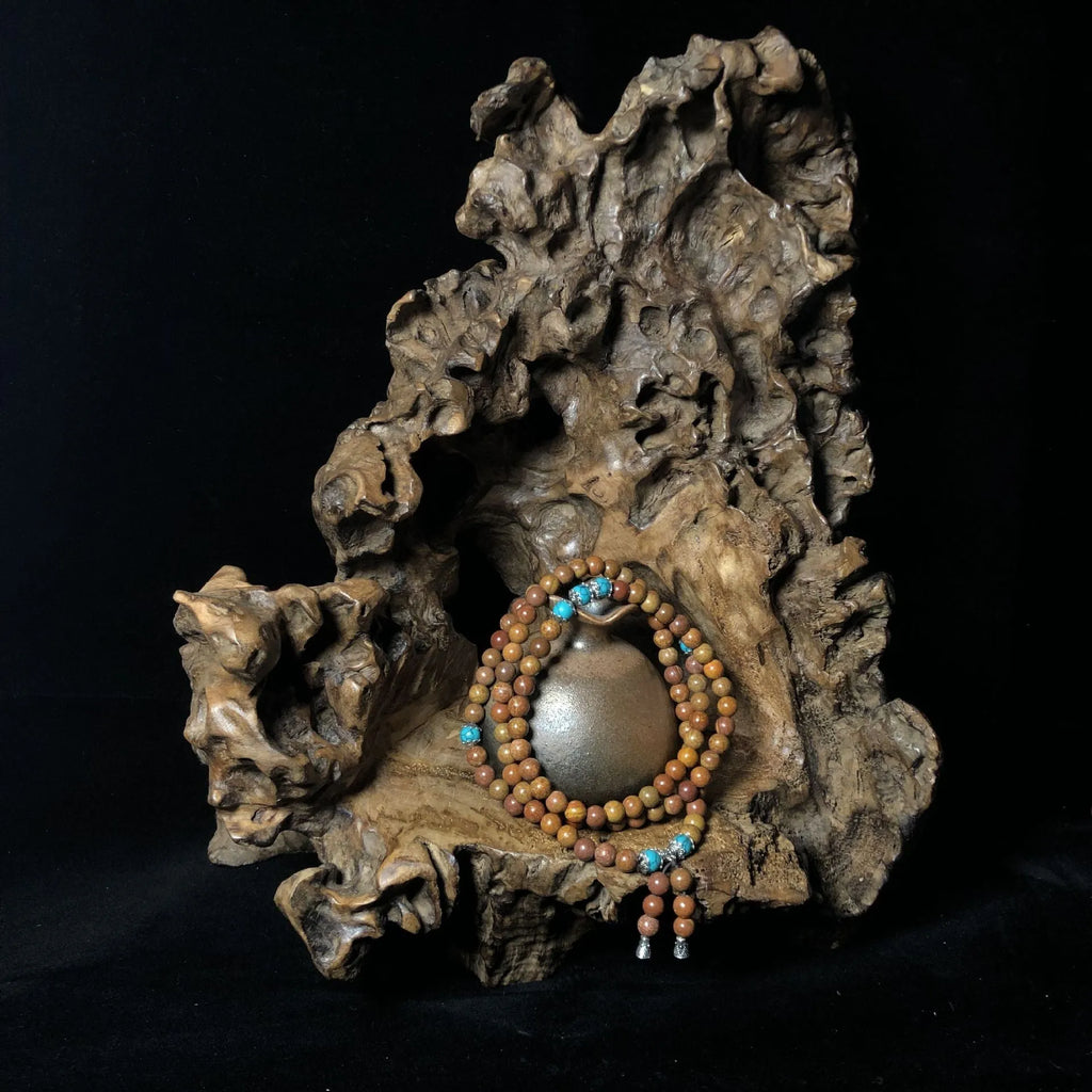 108 bead Lvzhu stone bracelet with 5-6mm geometric beads on wrist