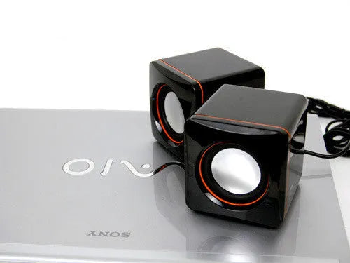 Small black square 2.0 computer speaker with USB power cable for desktop and laptop use.