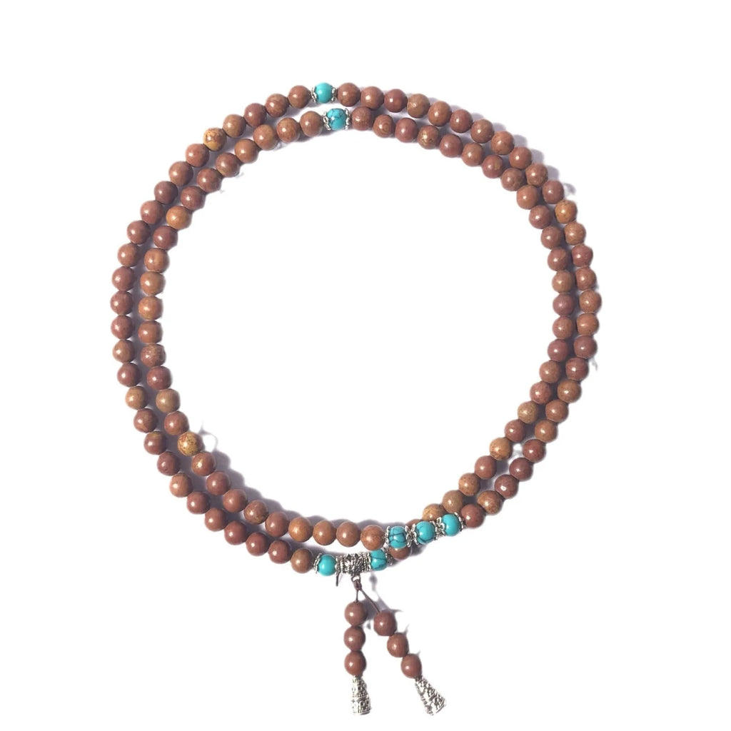 108 bead Lvzhu stone bracelet with 5-6mm geometric beads on wrist