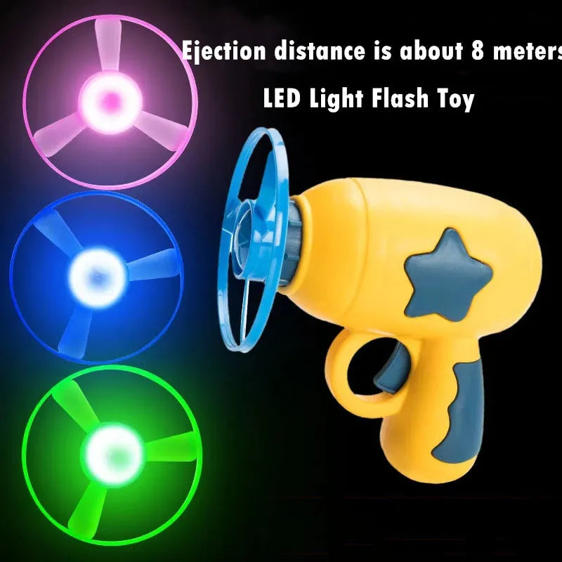 Flying saucer launcher toy set with plastic disc shooter gun, flashing discs, and target board, in blue, navy, pink, and yellow