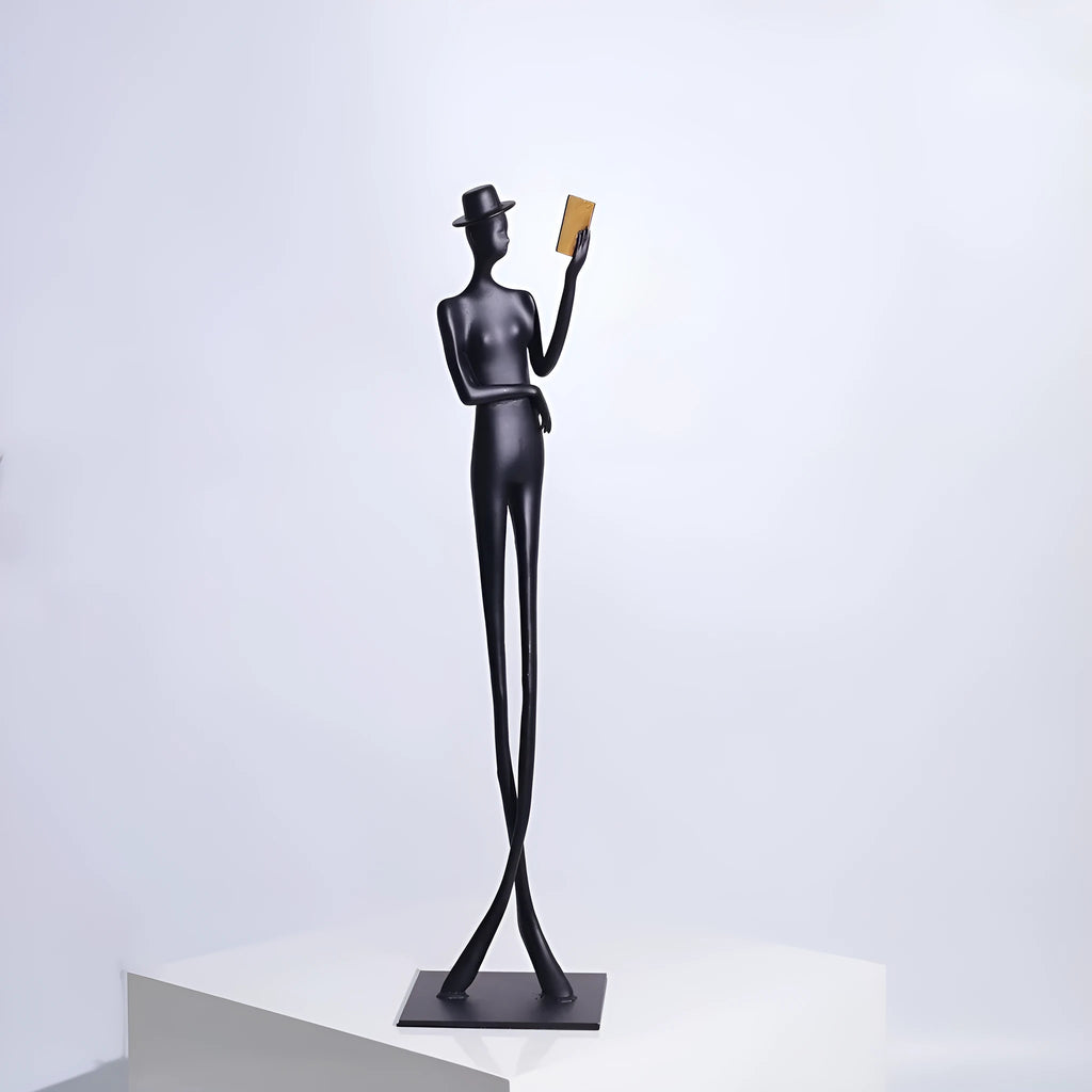 Black metal reading woman desktop sculpture made of cast aluminium measuring 51 cm tall