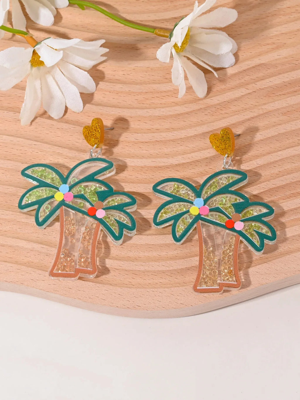 Acrylic drop earrings shaped like a strawberry, cherry, watermelon, pineapple, cake, ice cream, and coconut tree on a white background.