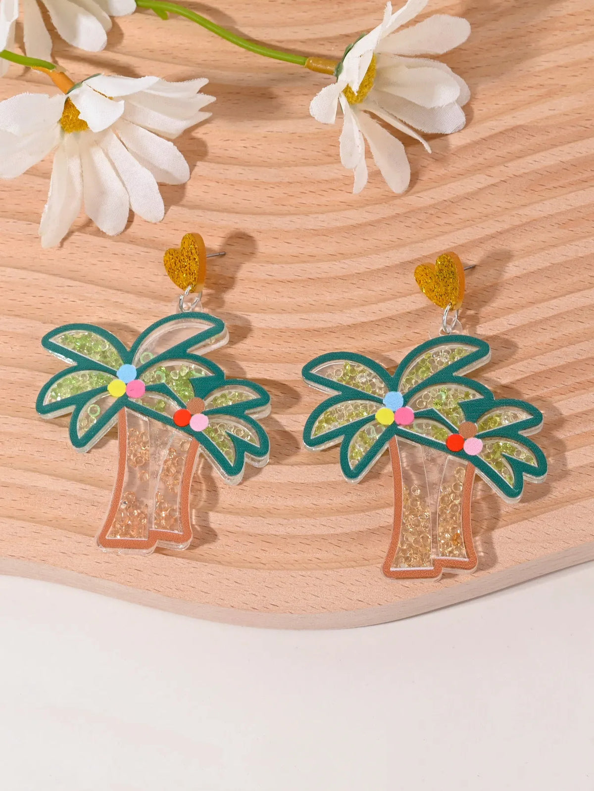 Acrylic drop earrings shaped like a strawberry, cherry, watermelon, pineapple, cake, ice cream, and coconut tree on a white background.