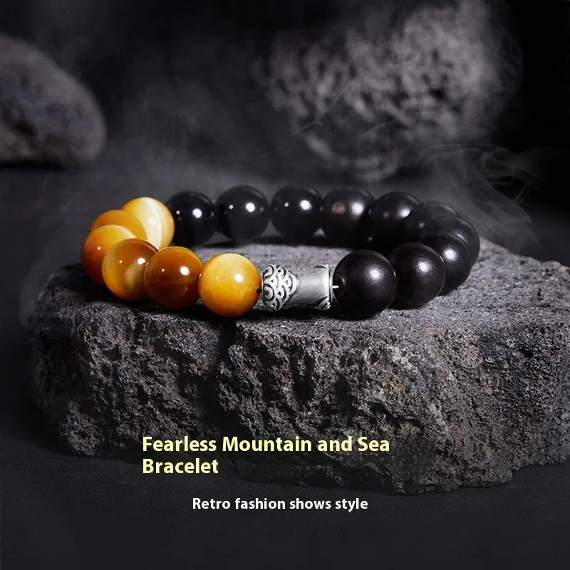 Men's handmade obsidian bracelet with sterling silver accents, Mountain and Sea Fearless design