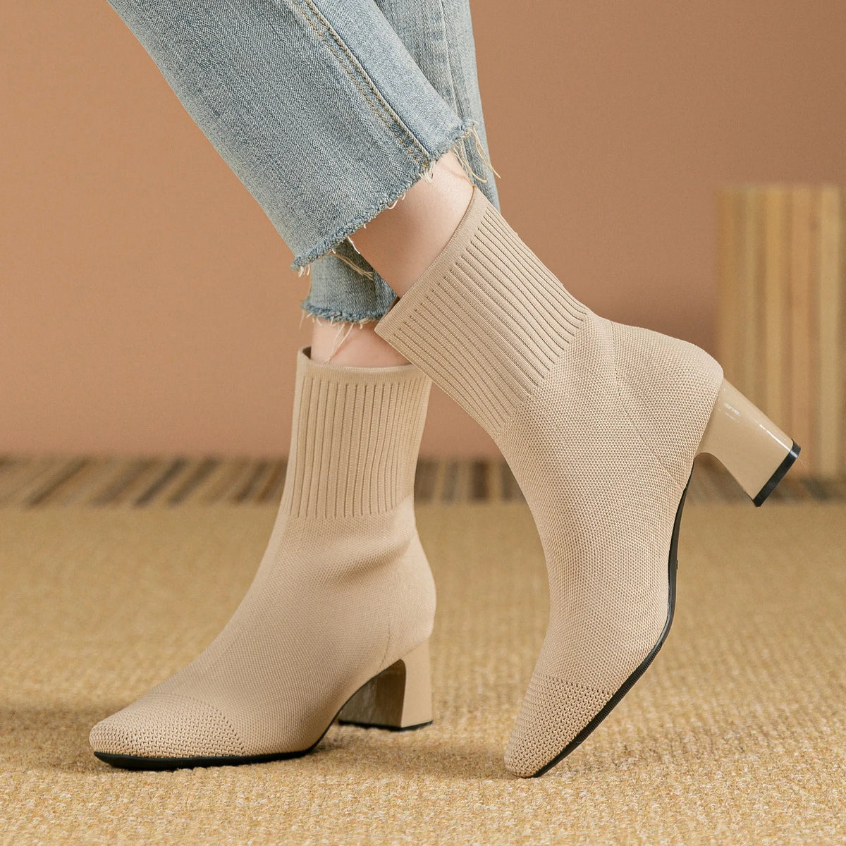Women's knitted sock boots with chunky high heel and square toe, mid-calf length, shown in black
