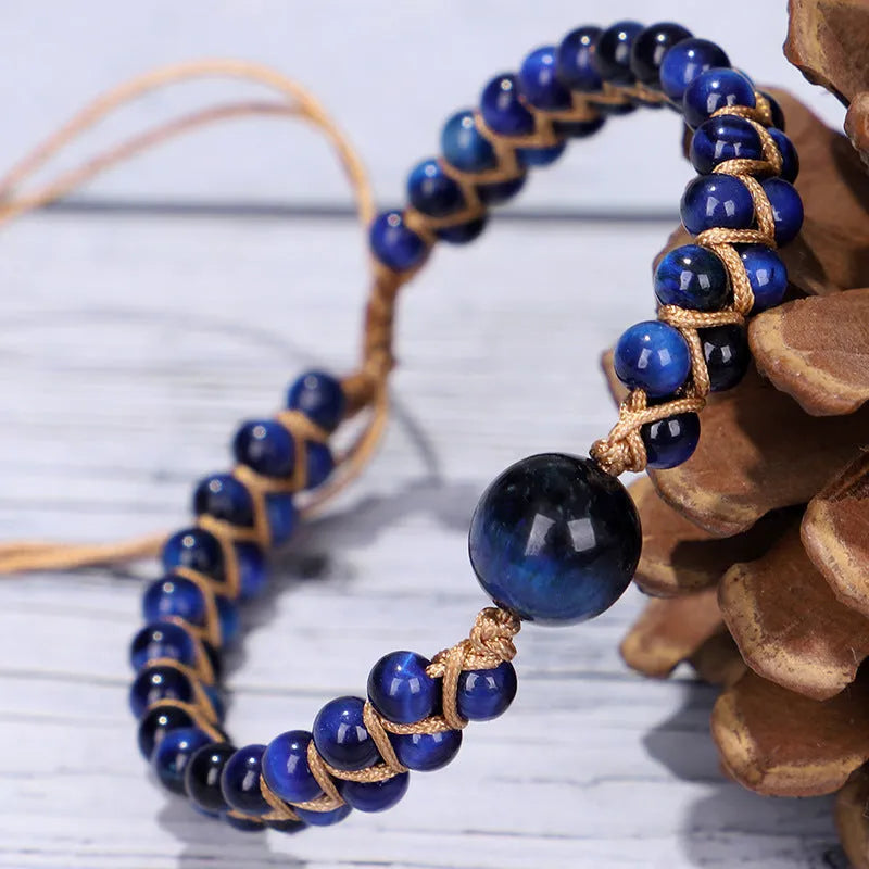 Close-up of a handmade woven pull bracelet with geometric pattern in blue Tigereye stone beads.