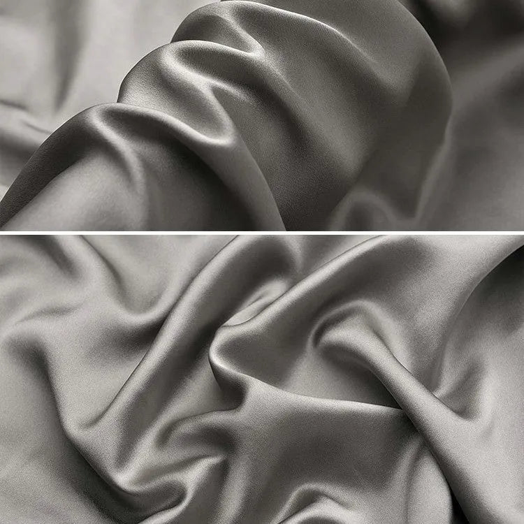 Dark grey 19 momme mulberry silk pillowcase showing envelope closure on a bed.