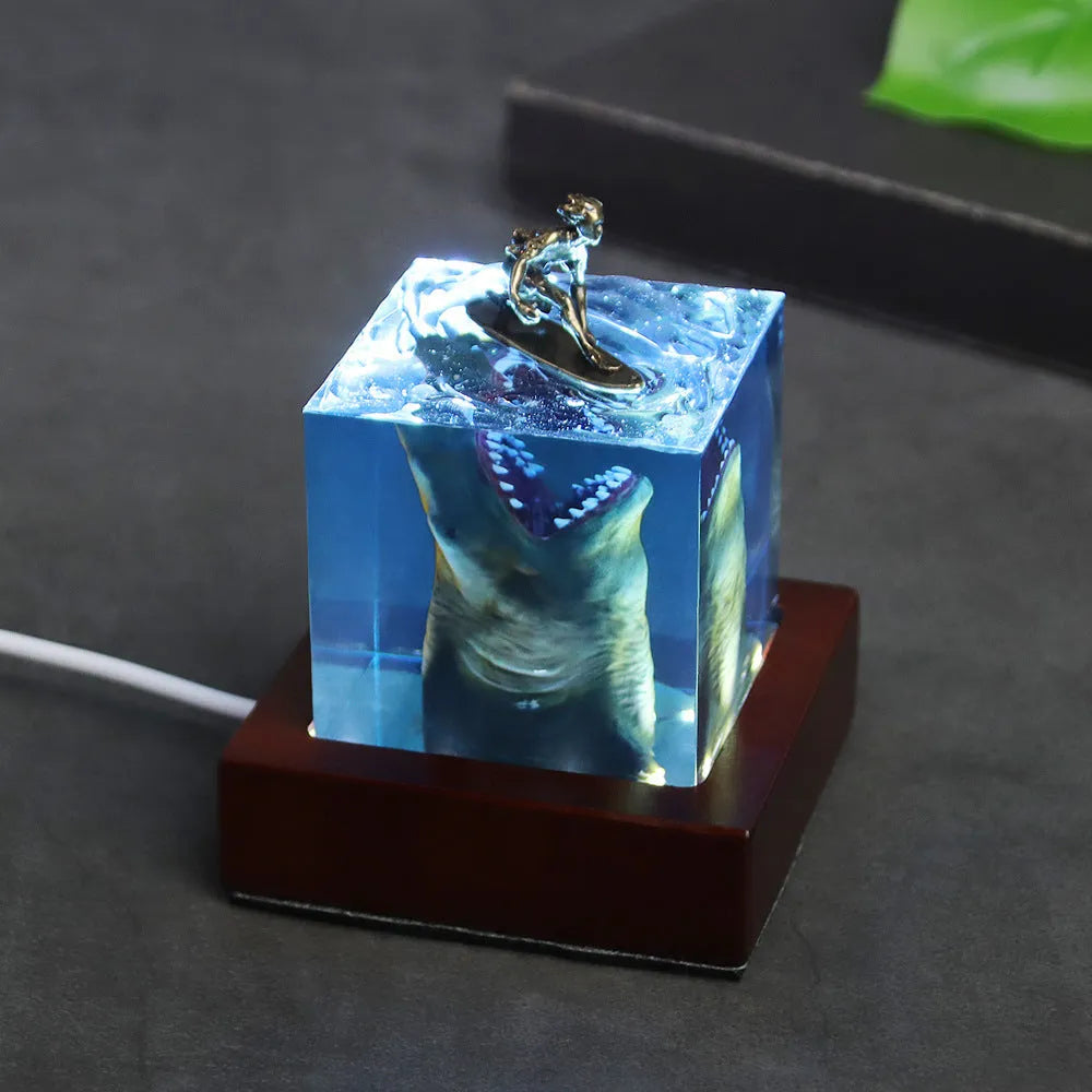 Ocean shark surfer micro landscape night light made of clear epoxy resin on a plastic stand
