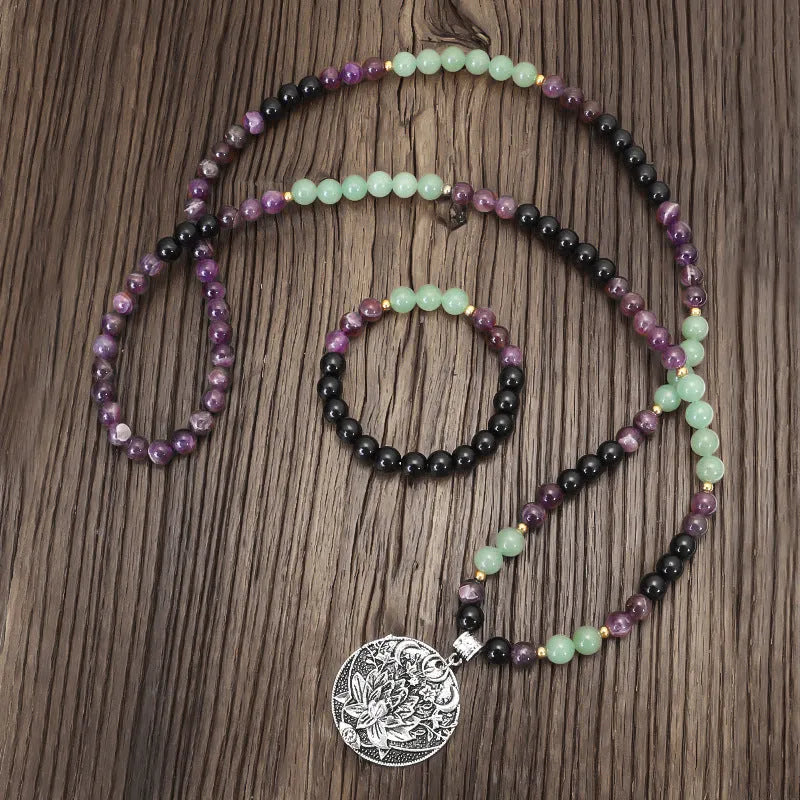 Long yoga lotus pendant necklace and matching bracelet set with stone beads and geometric design.