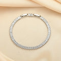 Rectangular brass bracelet with quadrilateral diamond pattern in gold or silver colour
