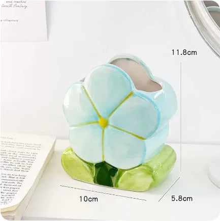 Ceramic desktop pen holder box with floral design in blue, pink, or purple.