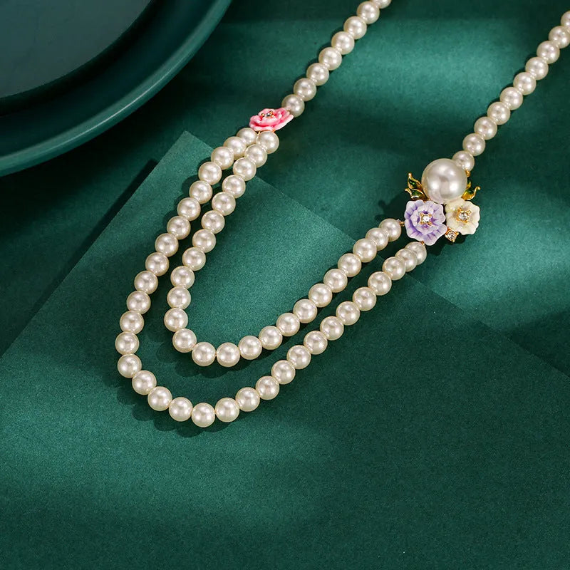 Enamel glaze diamond three-colour rose double-layer pearl necklace for women on display