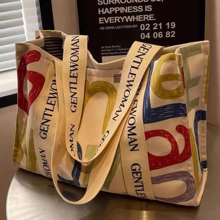 Large capacity canvas tote bag with printed letter design for women's travel and shopping