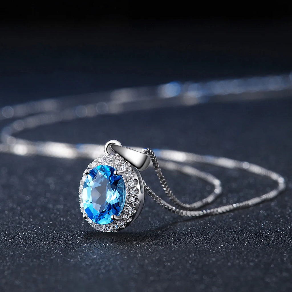925 sterling silver jewellery set with blue topaz gemstones showing earrings, ring, pendant and necklace