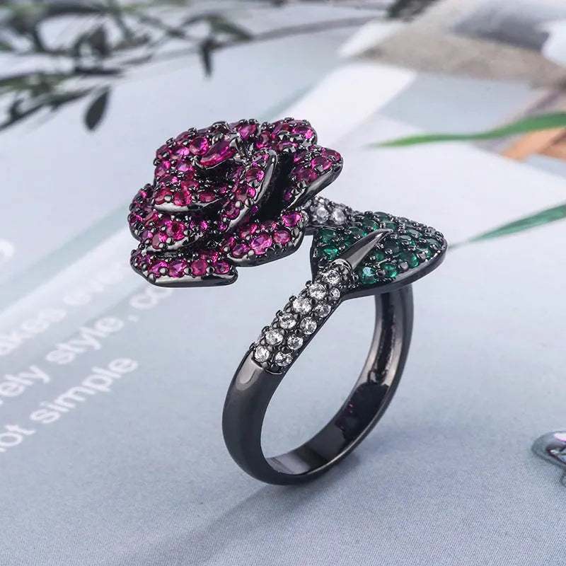 Black gold geometric flower personality ring with red corundum simulation stone on female hand