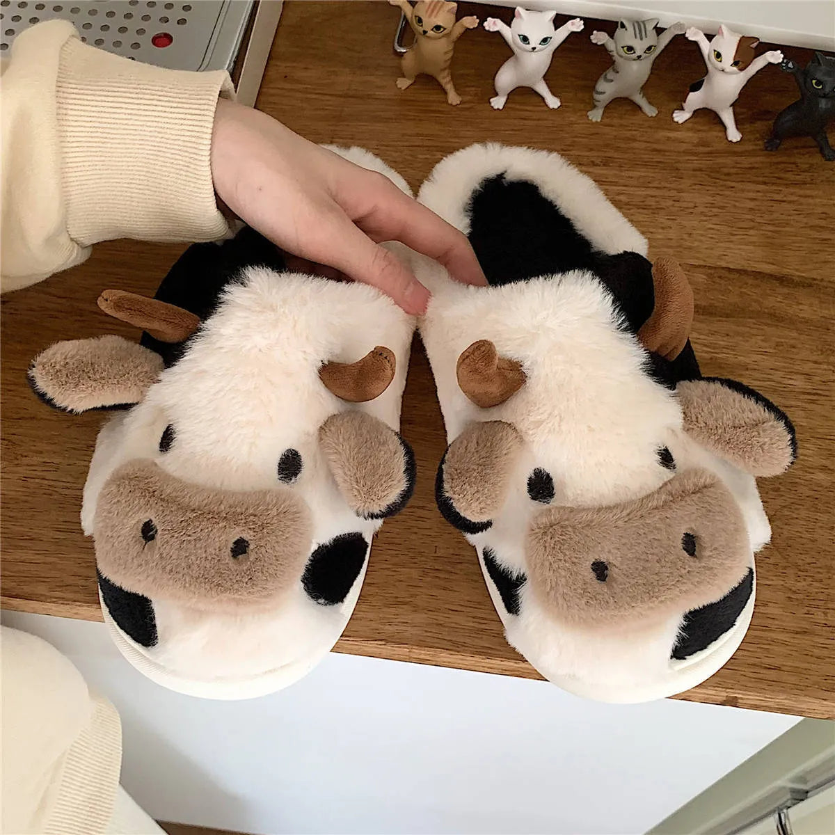 White cow animal house slippers with black spots, plush lining, and textured non-slip sole