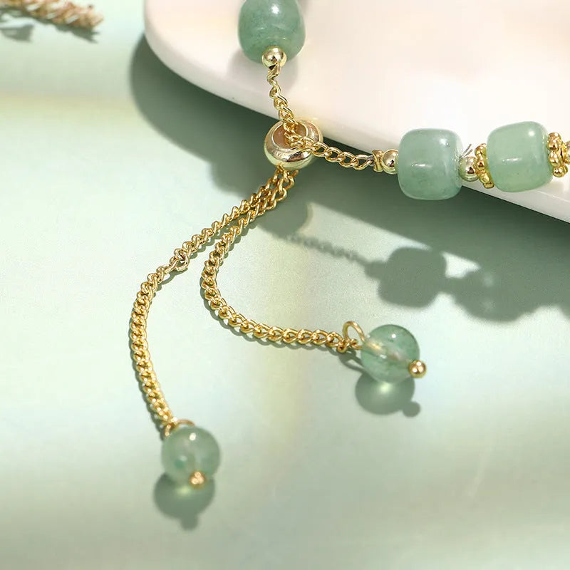 Rabbit charm bracelet with green aventurine and strawberry quartz stones on a gold plated copper chain