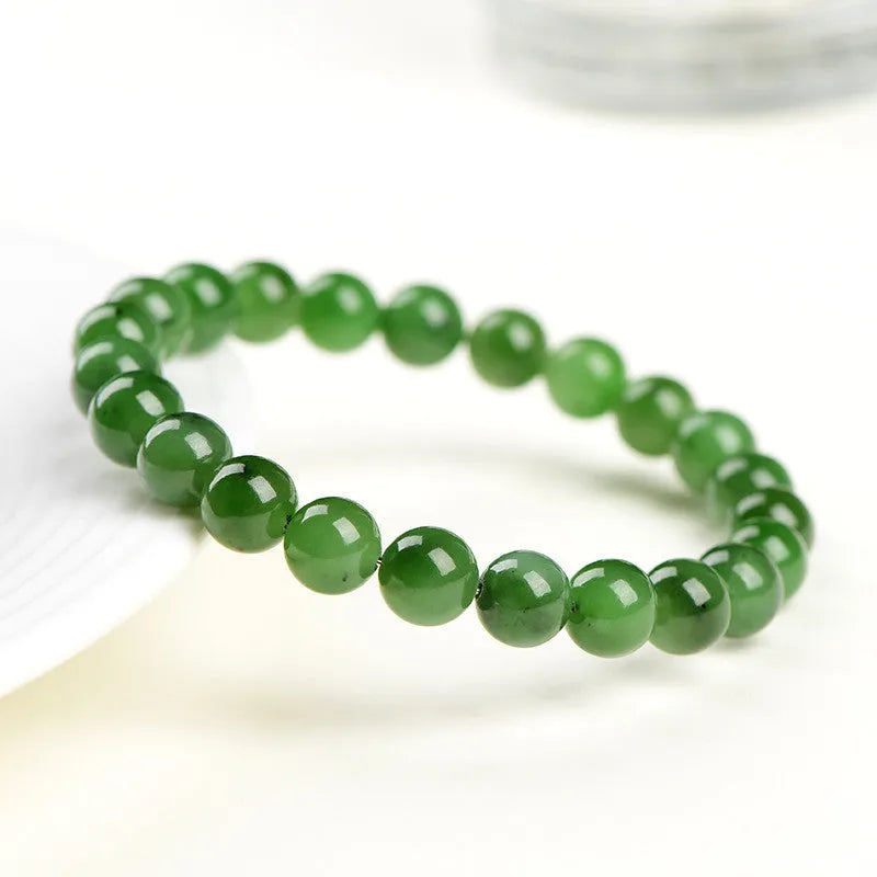 Natural Hetian jade jasper ball bracelet with polished beads on a wrist.