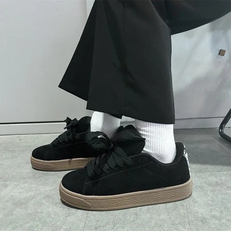 Black retro sneakers with round toe, lace-up front, and waterproof platform on rubber sole