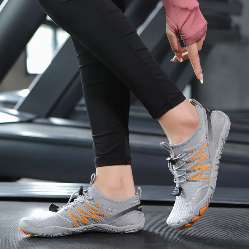 Lightweight indoor fitness training shoes with striped mesh upper and rubber sole in multiple colours.