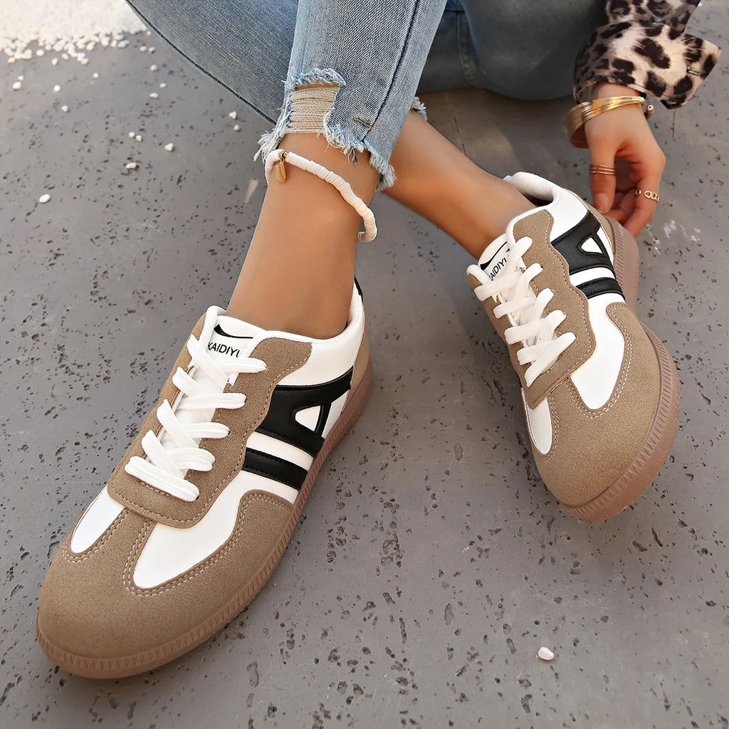 Women's retro colour matching lace-up jogging shoes in grey, showing cross-strap detail and platform sole.