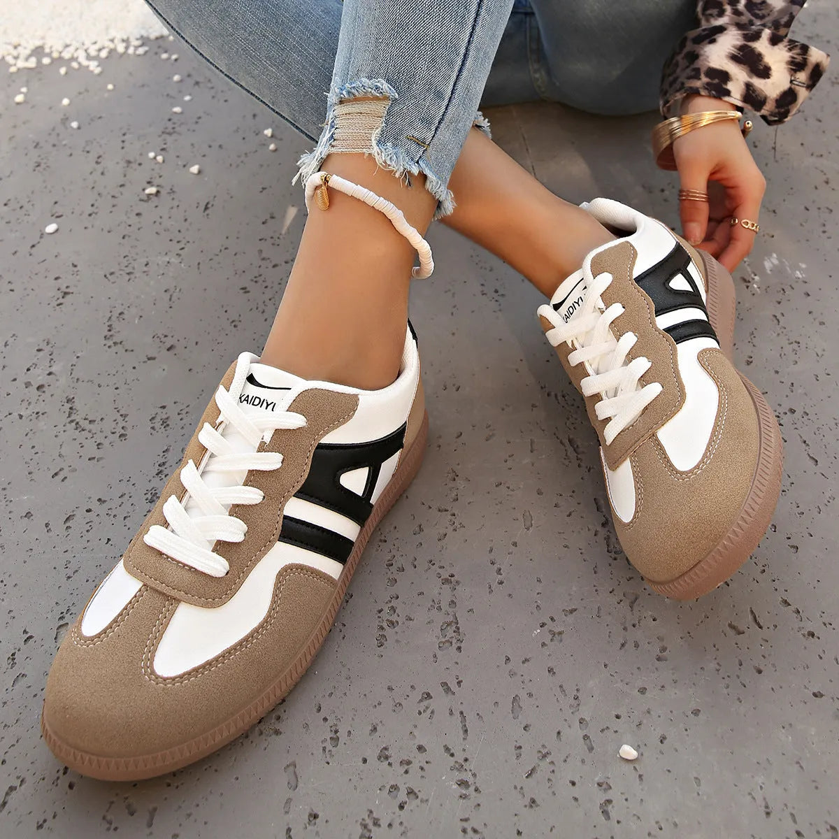 Women's retro colour matching lace-up jogging shoes in grey, showing cross-strap detail and platform sole.
