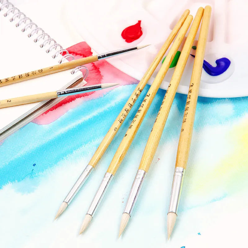 Set of six wooden-handled artistic pen brushes with pointed wool bristles for calligraphy and detailed painting.