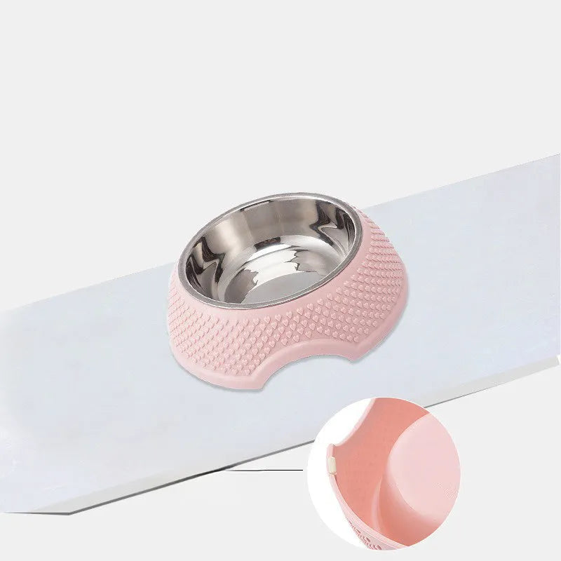 Set of four coloured stainless steel pet bowls with non-slip bases on a floor.
