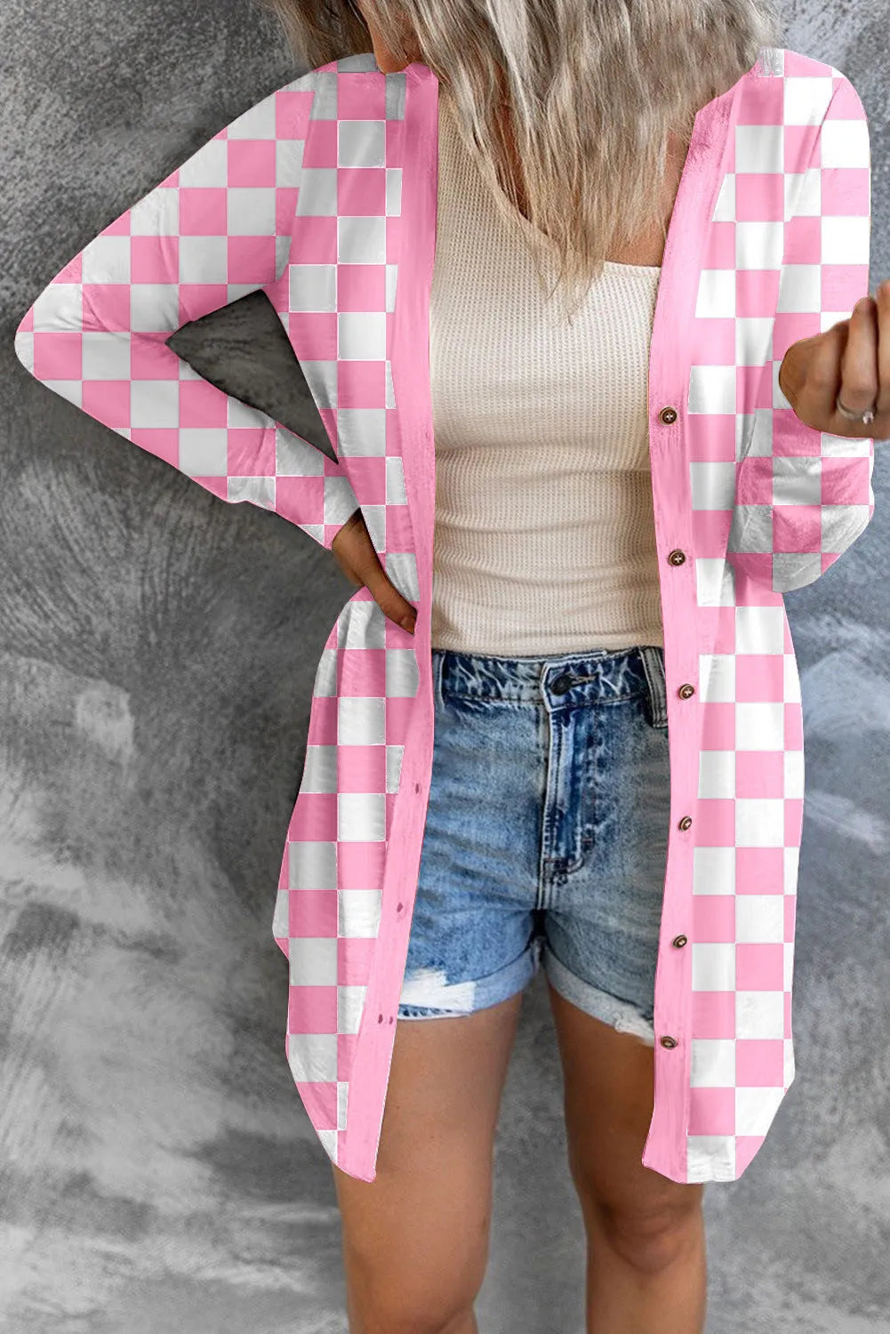 Women's long grey plaid knitted cardigan coat with a loose fit on a hanger.