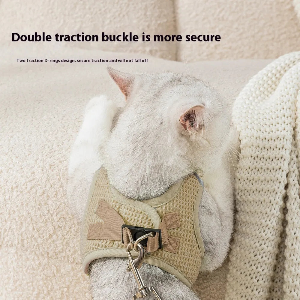 Brown cloth dog harness with an adjustable chest strap and a separate hand-held rope.