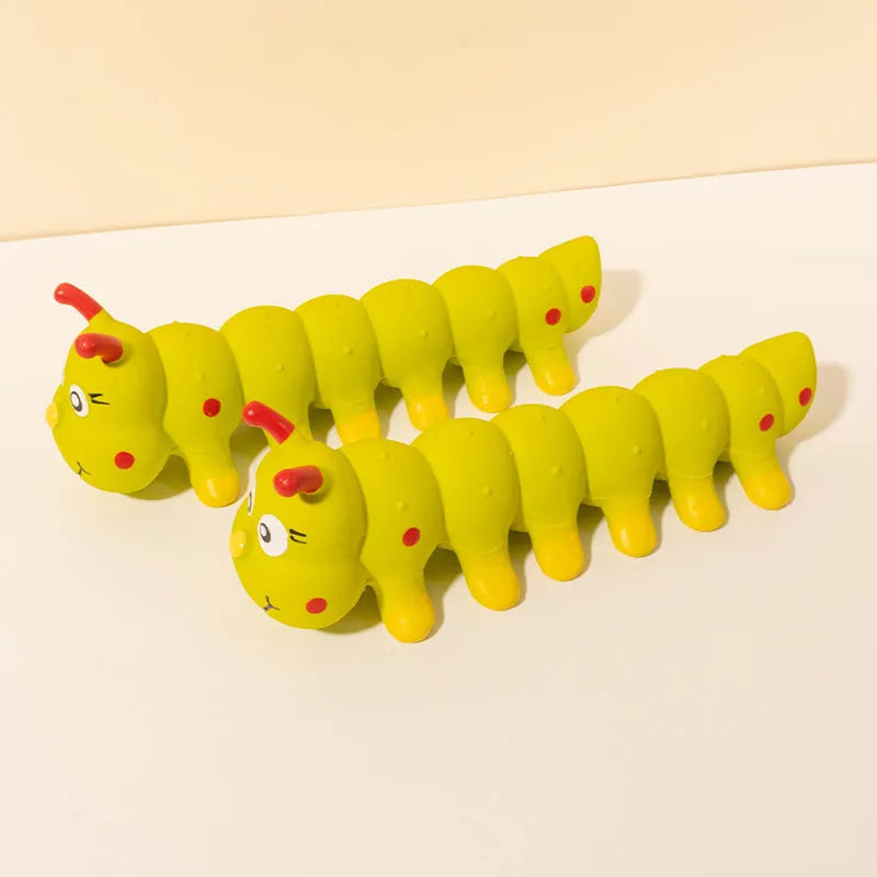 Yellow rubber caterpillar-shaped dog squeaky chew toy on a white background