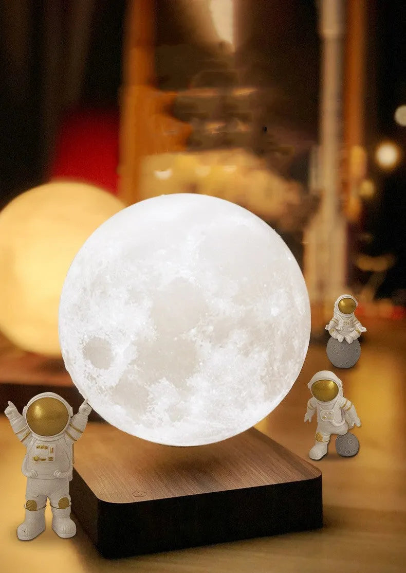 Maglev moon and planet LED night light floating above base with three astronaut figures nearby.