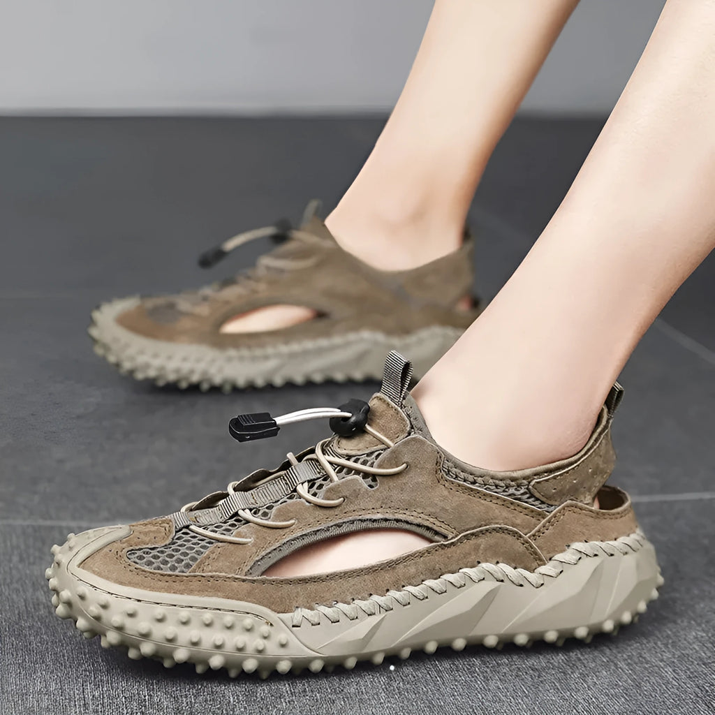 Men's black outdoor sports sandals with leather mesh upper and rubber sole showing elastic band closure