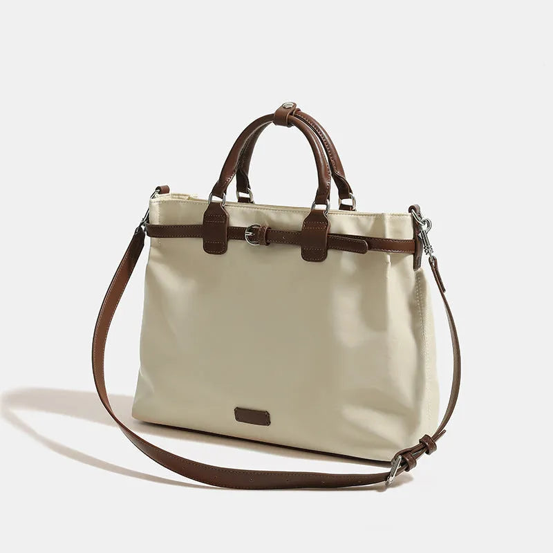 Women's nylon shoulder tote bag in a horizontal square shape showing internal organiser pockets.