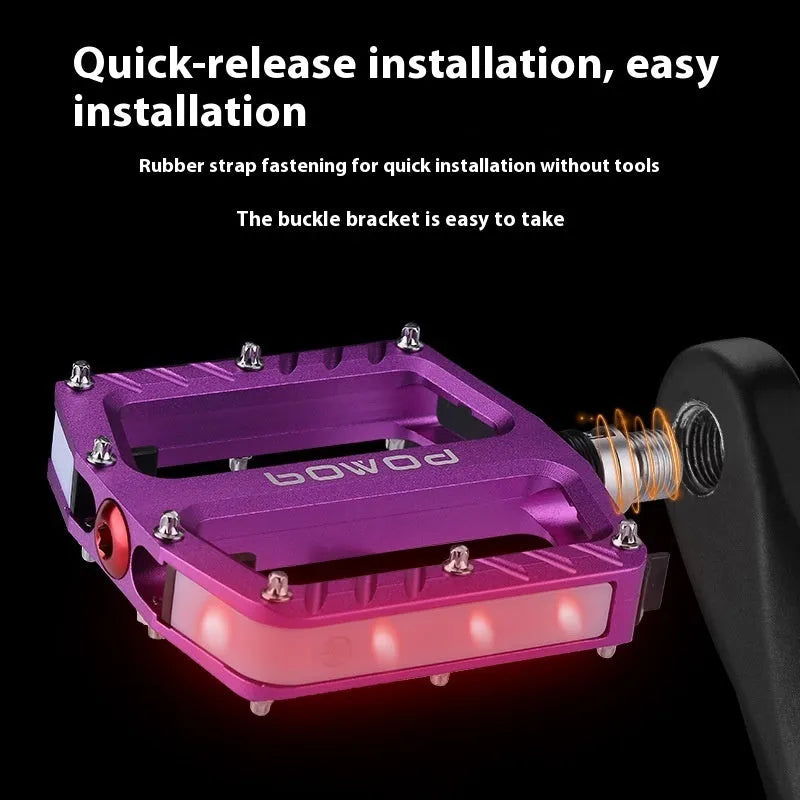 Aluminium alloy bicycle pedals with 710 LED lights in purple, black, titanium, red, and gold colours.
