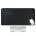 Large rectangular desk mouse pad with graphic pattern and natural rubber non-slip base on a wooden desk.