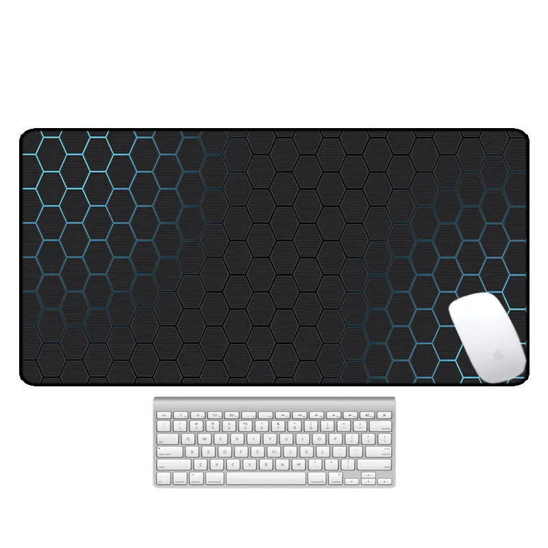 Large rectangular desk mouse pad with graphic pattern and natural rubber non-slip base on a wooden desk.