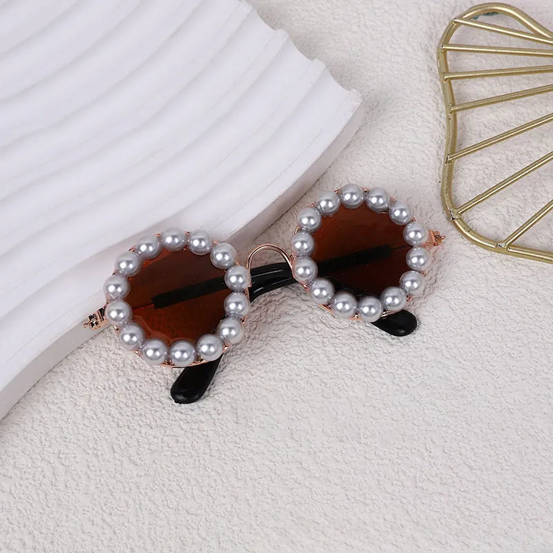 Round pearl-rimmed sunglasses for a dog or cat costume, shown in multiple colours.