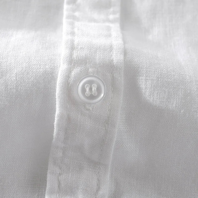 Man wearing a light blue loose fit short sleeve linen shirt for casual summer wear.