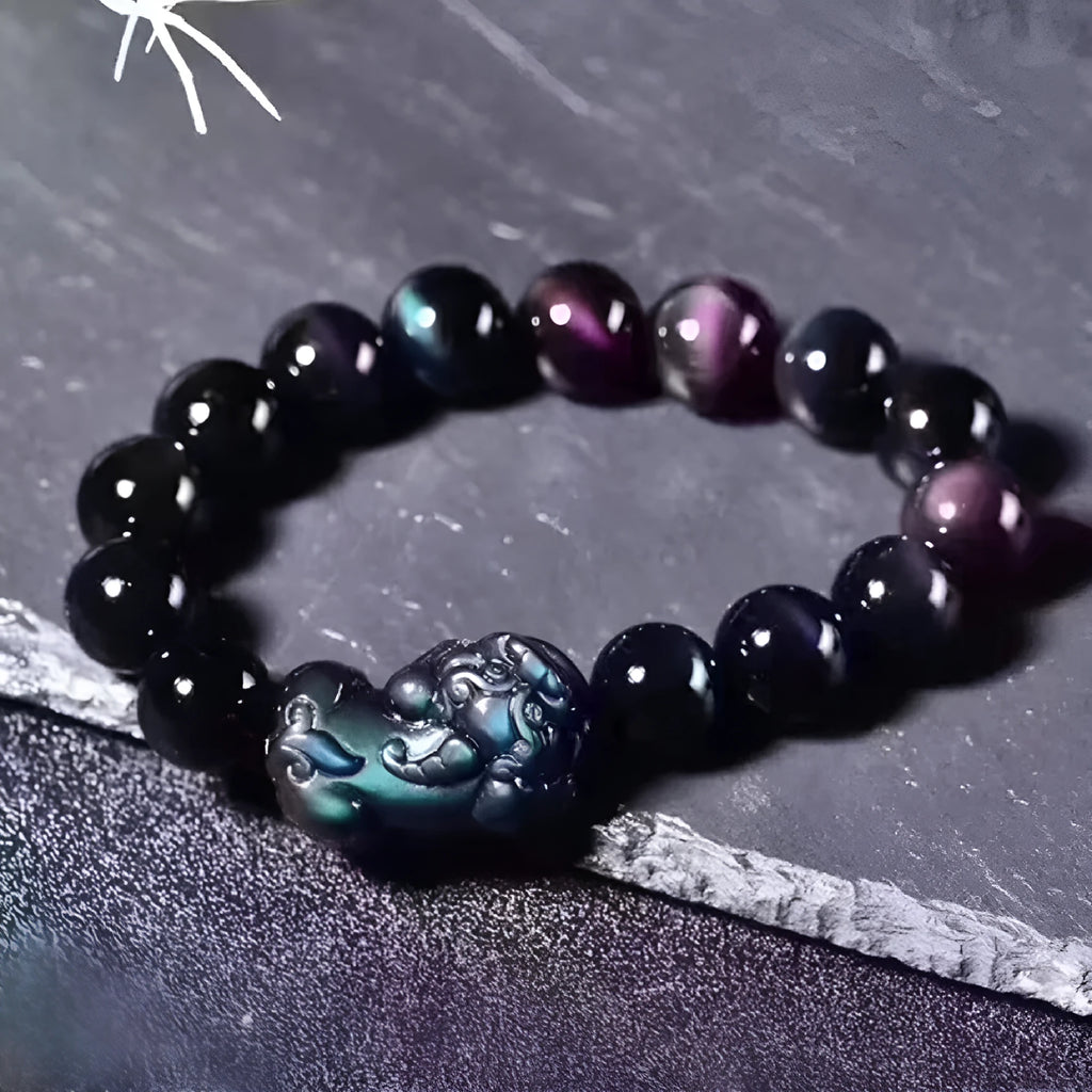 Natural eye obsidian crystal bracelet in ice colour on a wrist, showing bead sizing options.