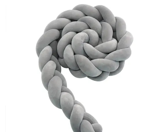 Braided knot design crib bumper in spandex velvet, shown in a light grey colour wrapped around crib slats.