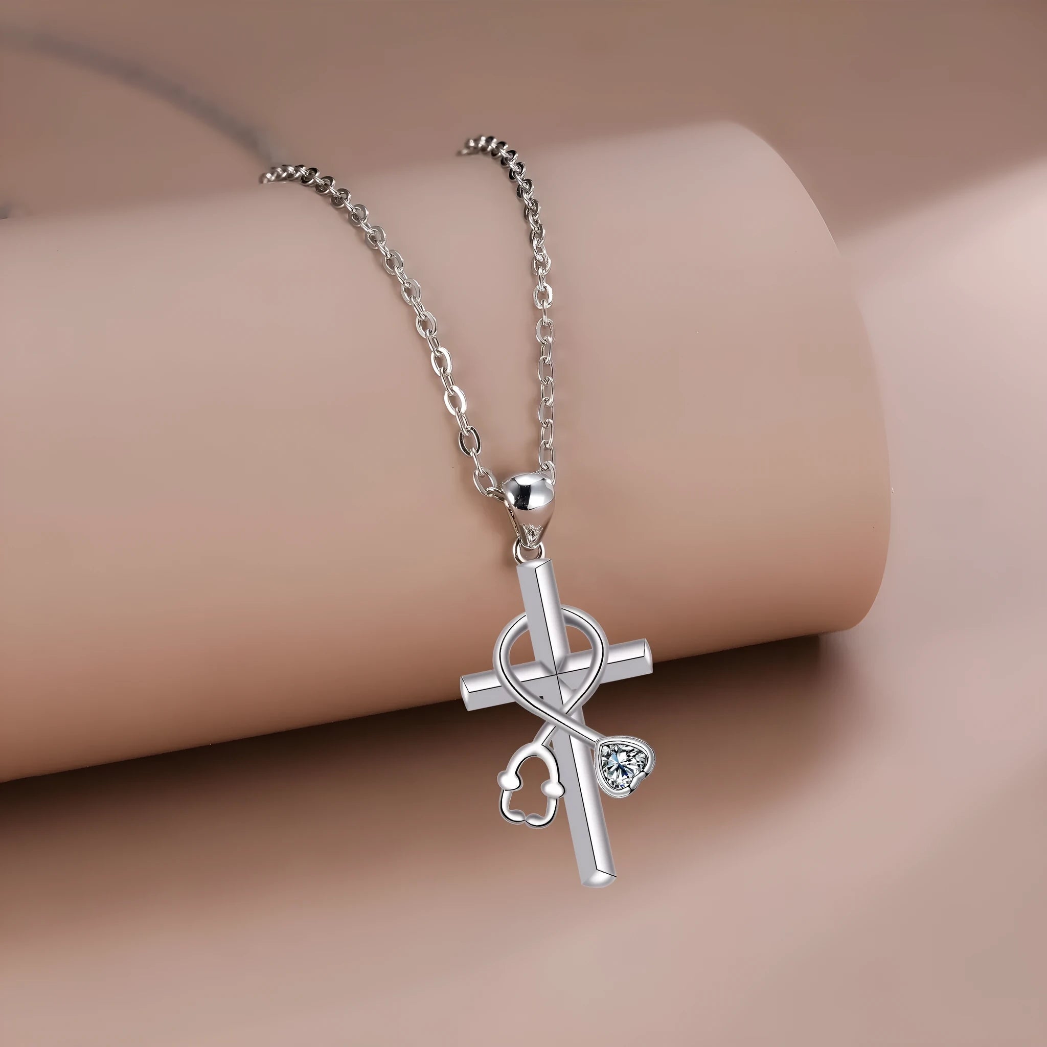 Copper cross stethoscope pendant necklace on a cross chain with electroplated finish.