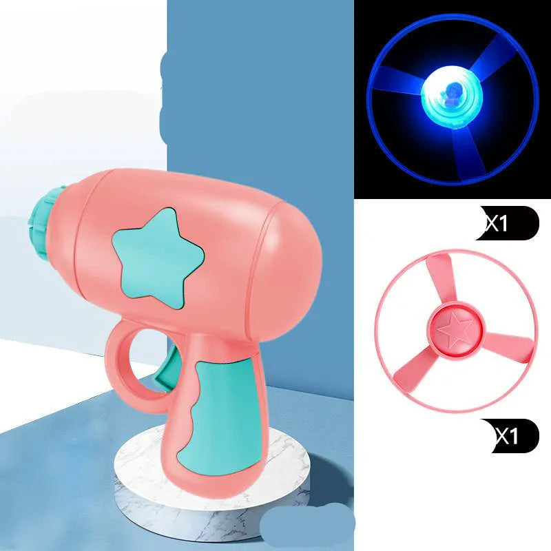 Flying saucer launcher toy set with plastic disc shooter gun, flashing discs, and target board, in blue, navy, pink, and yellow