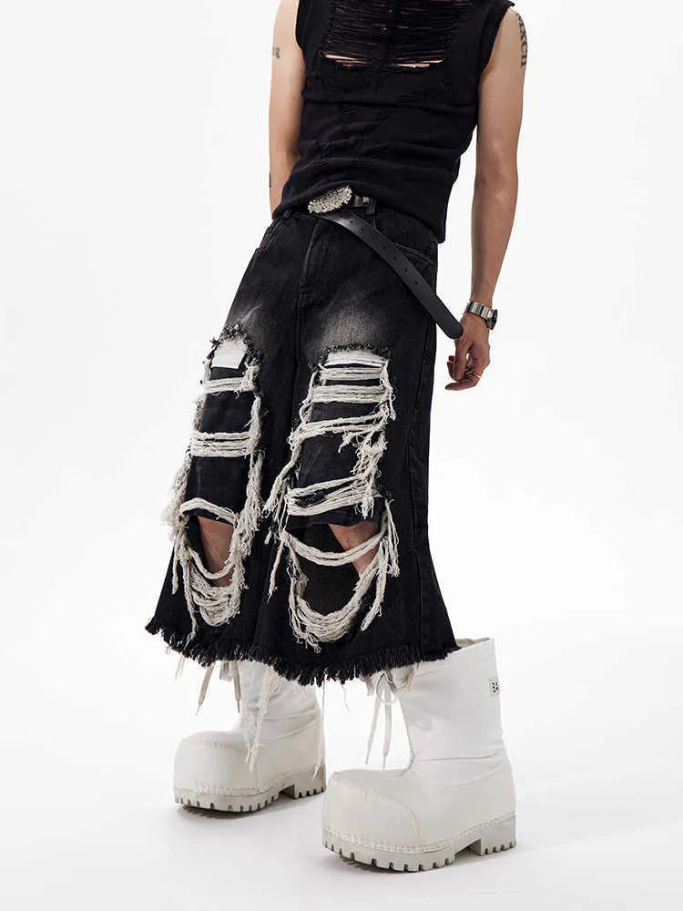 Women's black cropped wide-leg jeans with distressed patch details and mid-high waist