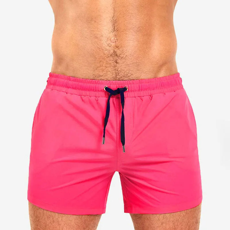 Man's solid colour polyester swimming shorts with mesh lining for sports and fitness.